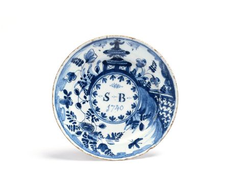 A delftware plate  dated 1740, painted in blue with the initials 'SB' above the date 1740, within a central roundel surrounde