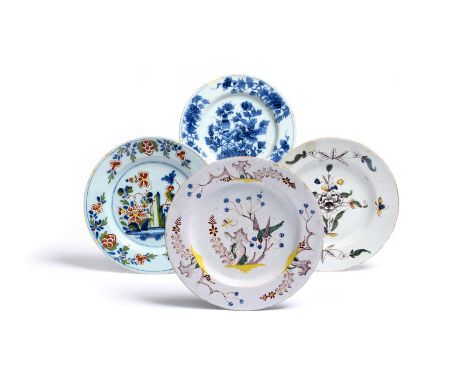 Four delftware plates  c.1730-60, one Lambeth and painted with a parrot perched among Oriental branches, one painted in blue 