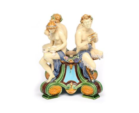 A Minton Majolica jardinière base  c.1875, set with two satyrs and two nymphs holding various attributes, each seated above a