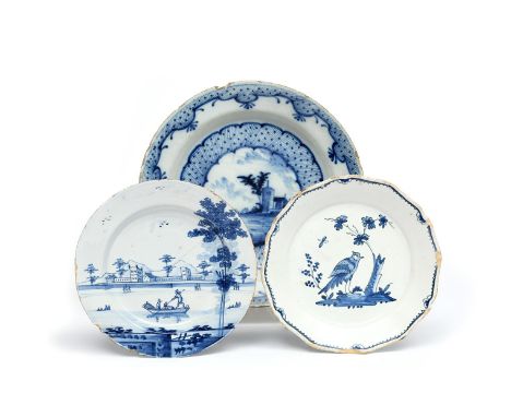 A delftware plate  c.1760, painted in blue with three figures in a boat before long buildings on the shore, a heavily potted 