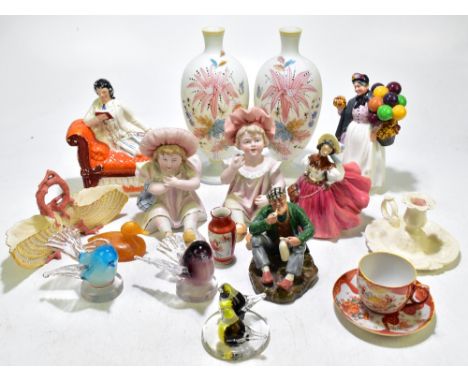 A group of ceramic figures including a Staffordshire figure of a reclining gentleman, two bisque piano babies, Royal Doulton 