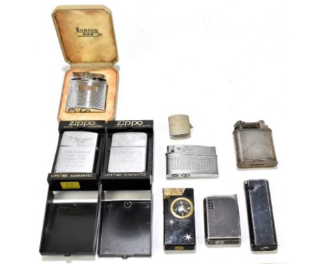 A small group of lighters including a Dunhill silver plated example with engine turned decoration, height 52mm, a Zippo light