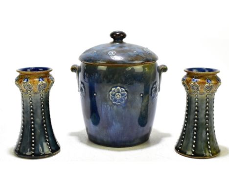 ROYAL DOULTON; a stoneware twin handled lidded biscuit twin barrel with floral devices in relief, stamped marks and number 85