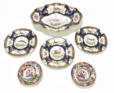 A 19th century hand highlighted bowl of shaped oval form and decorated with pheasants and exotic birds, on a cobalt blue grou
