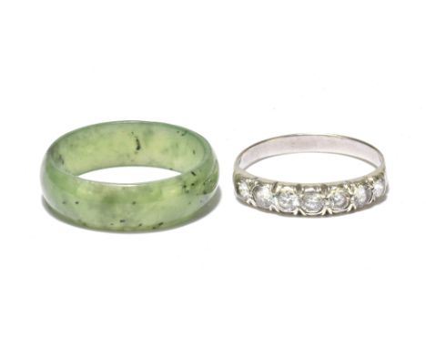 A white metal seven stone dress ring and a jade coloured ring (2).Additional InformationPlease note it is not set with diamon