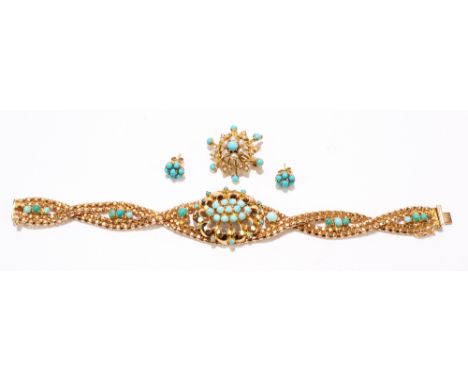 A yellow metal and turquoise set bracelet, with an open work centre section oval and overlapping strap, stamped ‘750’, length
