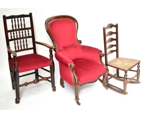 A Victorian mahogany framed nursing chair in red upholstery on cabriole front supports to castors, a country spindle-back arm