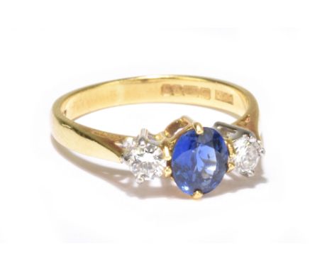 An 18ct yellow gold three stone diamond and sapphire ring, the sapphire flanked by two 0.15diamonds, size N, approx 3.4g.Addi