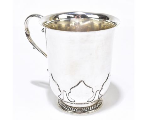 ADIE BROS; a George V hallmarked silver mug with scrolling handle and spreading circular foot, Birmingham 1930, height 11.75c