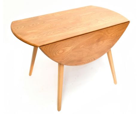 ERCOL; a contemporary light elm drop leaf dining table raised on tapering block supports, length 112cm, height 72cm, together