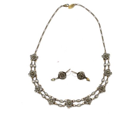 KENNY MA; a base metal necklace set with nine floral mounts, length 41cm, with a matching pair of earrings and presented in a