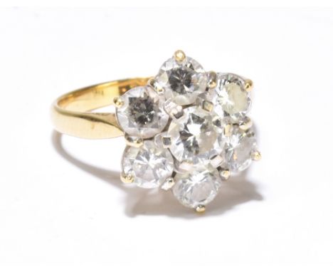 An 18ct yellow gold and diamond floral head ring, the central brilliant cut stone weighing approx 0.5ct within a border of si