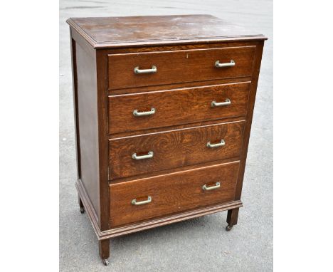 An early 20th century oak chest of four graduated long drawers on square legs, height 96cm, width 70.5cm, depth 46cm.Addition