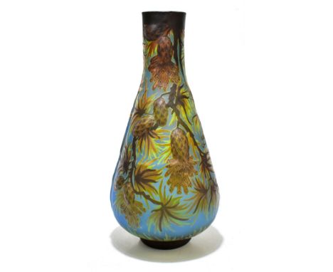 AFTER EMILE GALLE; a moulded glass vase decorated with pine cones and leaves against a blue ground, height 36cm.Additional In