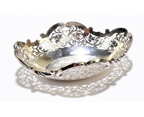 A white metal bowl of oval form, with pierced floral and scrolling detail, stamped 'Silver', length 17cm, approx. 6.45ozt/200