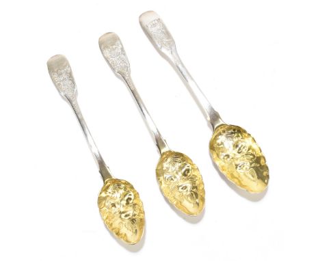 A George III hallmarked silver berry teaspoon, the gilded bowl repoussé decorated with berries and floral detail, the termina