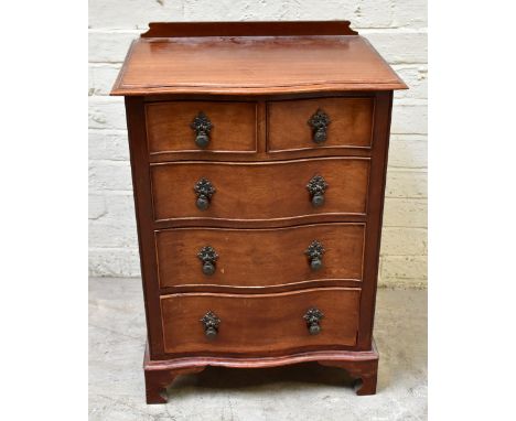 A small mahogany serpentine chest with two short over three long drawers on ogee bracket feet, height 72cm, width 50cm, depth