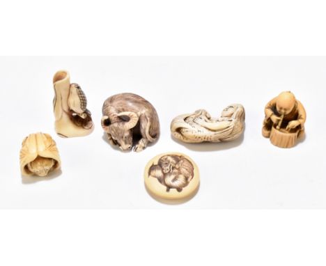 A late 19th century Japanese carved ivory netsuke modelled as a seated male figure and signed to red plaque to the base, heig