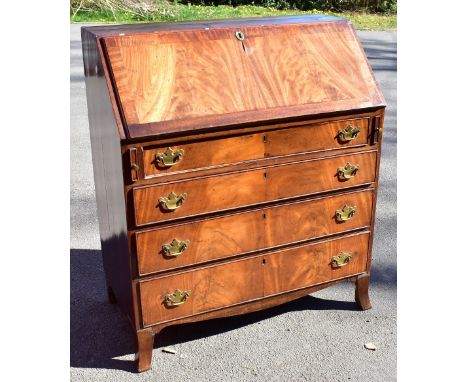 A 19th century mahogany bureau, the fall front enclosing pigeon holes and an arrangement of five drawers, above one short ove