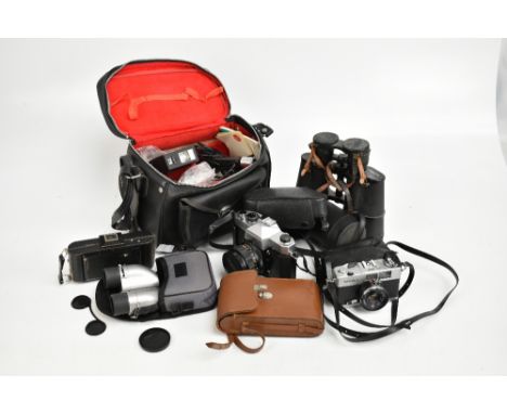 A pair of Sotem 7x50 binoculars, a Yashica TL-Electro camera and various other cameras.