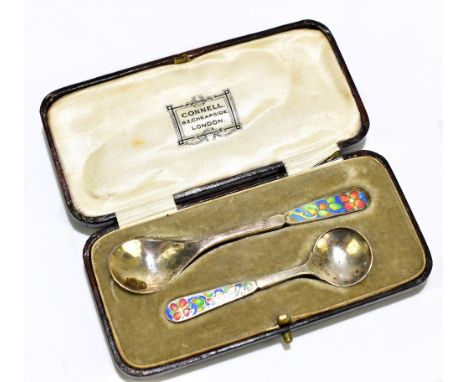 BERNARD INSTONE; a cased set of two George V hallmarked silver and floral enamelled cruet spoons, Birmingham 1928, the larger