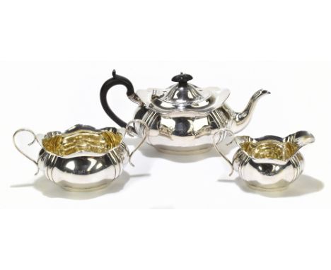 RF MOSLEY; a George V hallmarked silver three piece tea set of shaped oval form, with gilded interior and panelled detail, Sh