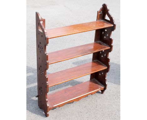 A Victorian mahogany four tier hanging shelf, the serpentine sides with pierced detailing, height 89cm, width 66.5cm, depth 1