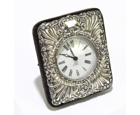 RBB; an Elizabeth II hallmarked silver mounted quartz mantel clock, the circular dial set with Roman numerals, with easel bac