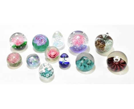 Twelve assorted glass paperweights, to include a Seaform example, diameter 7cm, a Mtarfa example in the form of an apple, a&n