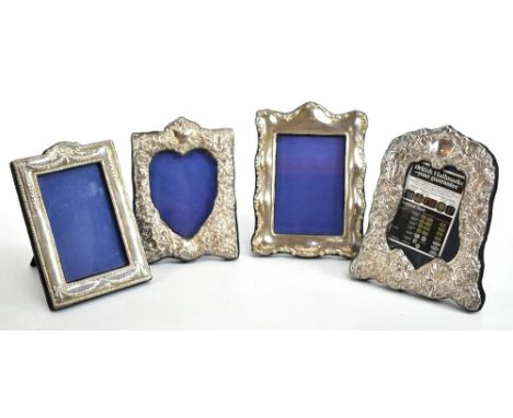 Four modern hallmarked silver photograph frames, all Edinburgh 2000, comprising a rectangular example with serpentine border,