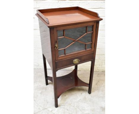 An Edwardian mahogany cabinet, with three quarter gallery above an astraglazed door and drawer, above an undertier on molded 