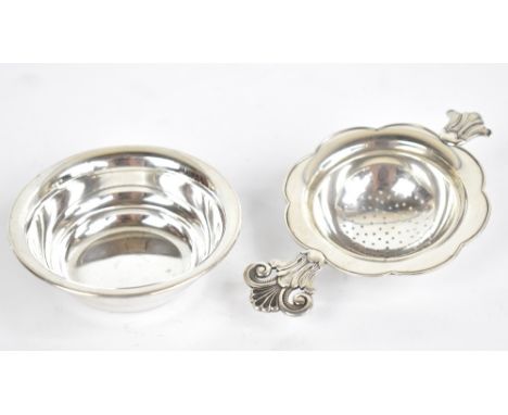 A Norwegian silver tea strainer with stylised foliate handle and stand with Swedish import marks, length of strainer 11.6cm, 