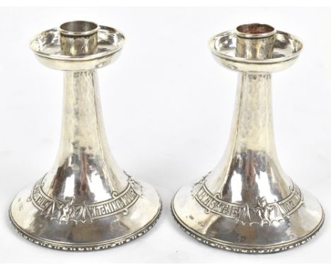 F.J. ROSS &amp; SONS; a pair of Arts &amp; Crafts&nbsp;hallmarked silver candlesticks in the manner of Albert Edward Jones, o