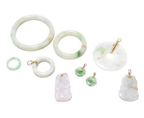 A group of polished jade and similar Chinese pendants and ring loops Including a yellow metal example modelled as a bi-disc, 