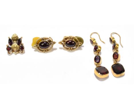 A pair of yellow metal and garnet four sectioned drop earrings, length of drop approx 42mm, a pair of cabochon set ear clips,