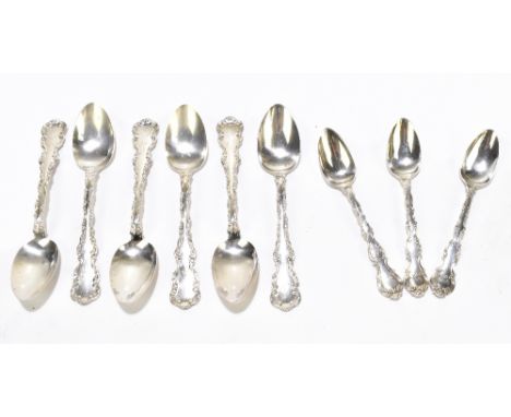 A set of six sterling silver fruit spoons each with cast scrolling decoration to handles and with engraved initials AHR, toge