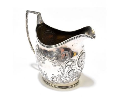 A George III hallmarked silver helmet shaped cream jug, with engraved scroll detail and vacant cartouche, London 1805, height