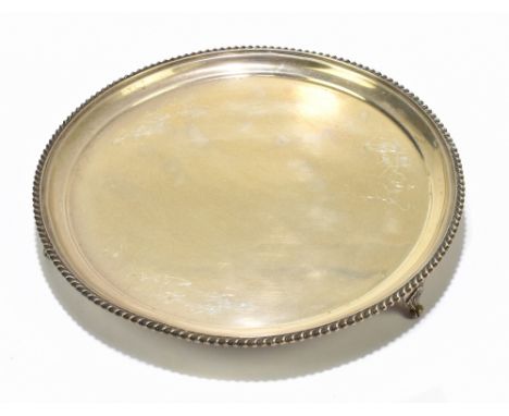 WILLIAM HUTTON &amp; SONS; a George VI hallmarked silver salver with cast rim, raised on three open shell feet, Sheffield, 19