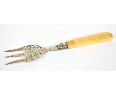 LEVESLEY BROTHERS; a Victorian silver and ivory simulant handled bread fork with pierced foliate scroll and bright cut detail