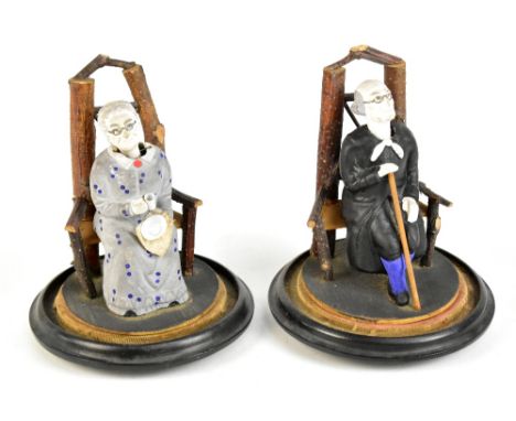 A pair of late 19th/early 20th century Folk Art bisque and wood nodding figures, possibly American, modelled as a seated elde