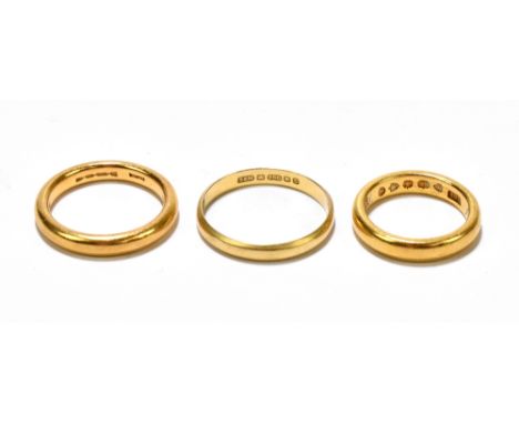 Two 22ct yellow gold wedding bands, size I and size M 1/2 (13), also an 18ct yellow gold wedding band size R, approx 2.3g (3)