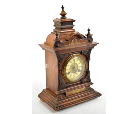 A late 19th century German walnut eight day mantel clock, with Roman numeral chapter ring and Junghans movement striking on a