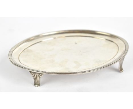 CRISPIN FULLER; a George III hallmarked silver oval teapot stand with reeded rim on four shaped feet, London 1802, 16 x 11.5c