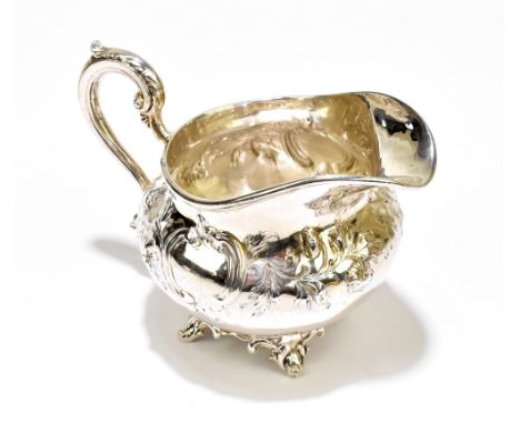 BENJAMIN PRESTON; an early Victorian hallmarked silver cream jug with embossed scroll decoration and twin vacant cartouches, 