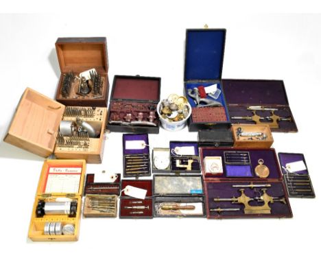 A group of pocket watch components including dials, cases and glasses for restoration and a group of boxed clock/watchmaking 