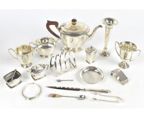 A group of variously hallmarked silver items including teapot, twin handled sugar bowl, cream jug, four division toast rack, 