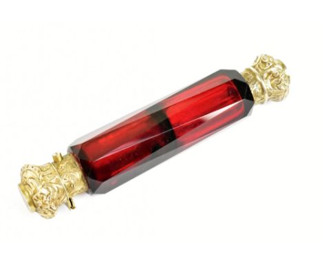 A Victorian gilt white metal mounted ruby glass double ended scent bottle, with hinged cover and screw cover profusely decora