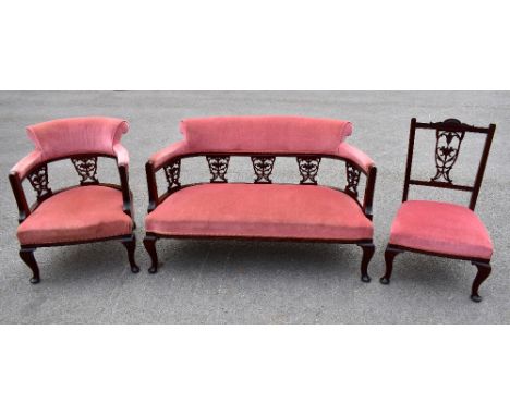 An Edwardian mahogany three-piece salon suite, with pierced vase splat backs, raised on cabriole supports, length of sofa 124