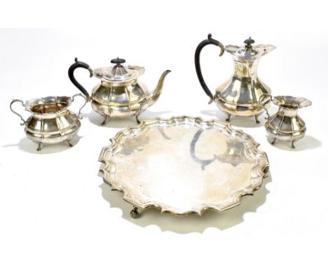 HAMILTON LAIDLAW &amp; CB &amp; CO; a George V hallmarked silver four piece tea set and tray, the tea set with panelled decor