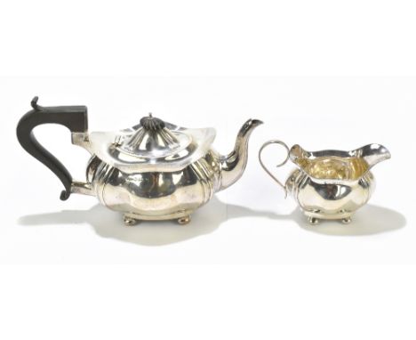 JOSEPH GLOSTER LTD; a George V hallmarked silver teapot and milk jug, each of shaped oval form with panelled decoration, Birm